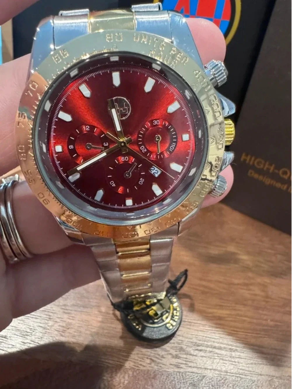 AJ watch, stainless steel, gold & silver toned, crimson red face